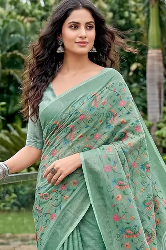 Sea green linen cotton blend saree with floral embroidery & tassel pallu