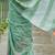 Sea green linen cotton blend saree with floral embroidery & tassel pallu