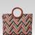  lines & loops tan jacquard chevron handheld bag
