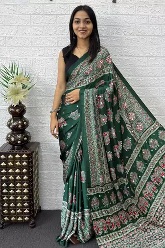 green color mirror work border with handcrafted red tassels (latkan) and ajarakh print gajji silk blend saree