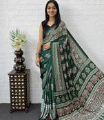 green color mirror work border with handcrafted red tassels (latkan) and ajarakh print gajji silk blend saree