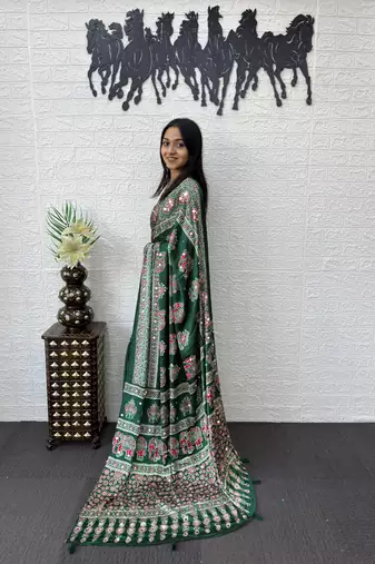 green color mirror work border with handcrafted red tassels (latkan) and ajarakh print gajji silk blend saree