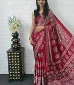 maroon color mirror work border with handcrafted red tassels (latkan) and ajarakh print gajji silk blend saree