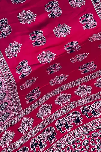 rani pink color mirror work border with handcrafted red tassels (latkan) and ajarakh print gajji silk blend saree