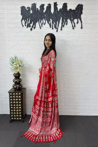 red color mirror work border with handcrafted red tassels (latkan) and ajarakh print gajji silk blend saree