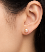 Pink freshwater pearl stud earrings with gold-tone backs