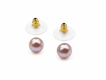 Pink freshwater pearl stud earrings with gold-tone backs pushing 3