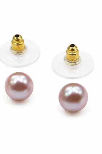Pink freshwater pearl stud earrings with gold-tone backs pushing