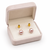 Pink freshwater pearl stud earrings with gold-tone backs pushing