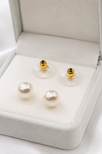 White pearl stud earrings with gold-tone push back clasps