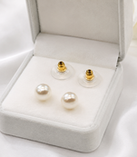 White pearl stud earrings with gold-tone push back clasps