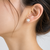 White pearl stud earrings with gold-tone push back clasps