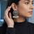 Oxidized silver peacock motif statement earrings with white pearl cluster drops