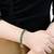 Rose gold plated green baguette stone studded adjustable bracelet jewellery for women