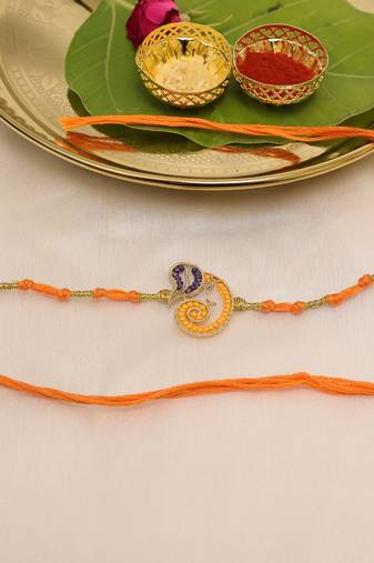 orange ganesha handcrafted beaded thread rakhi with roli chawal capsules