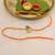 orange ganesha handcrafted beaded thread rakhi with roli chawal capsules