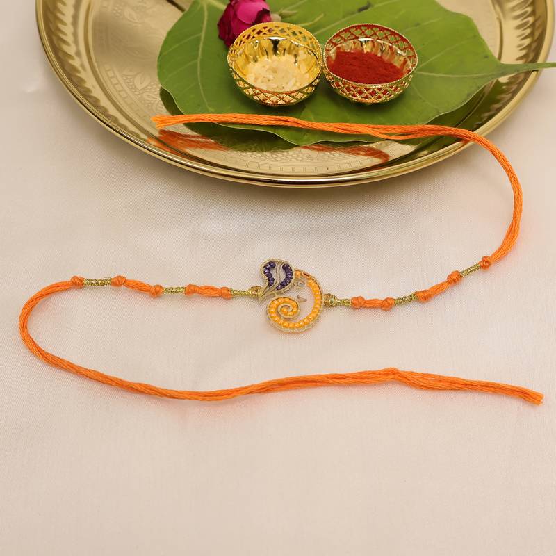 orange ganesha handcrafted beaded thread rakhi with roli chawal capsules