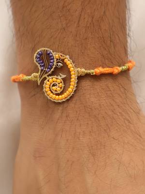 orange ganesha handcrafted beaded thread rakhi with roli chawal capsules 2