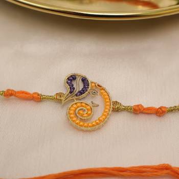 orange ganesha handcrafted beaded thread rakhi with roli chawal capsules 3