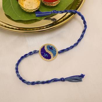 blue yin yang dual tone braided thread rakhi with roli chawal capsules 1