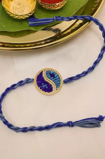 blue yin yang dual tone braided thread rakhi with roli chawal capsules