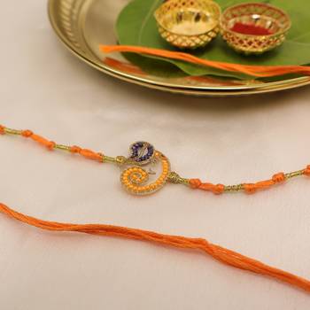 orange ganesha handcrafted beaded thread rakhi with roli chawal capsules 4