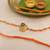 orange ganesha handcrafted beaded thread rakhi with roli chawal capsules