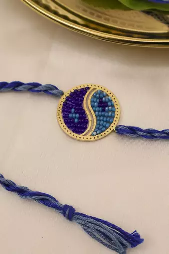 blue yin yang dual tone braided thread rakhi with roli chawal capsules