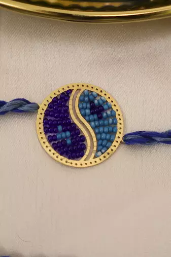 blue yin yang dual tone braided thread rakhi with roli chawal capsules