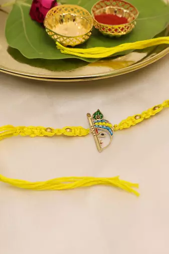 yellow krishna face beaded designer thread rakhi with roli chawal capsules
