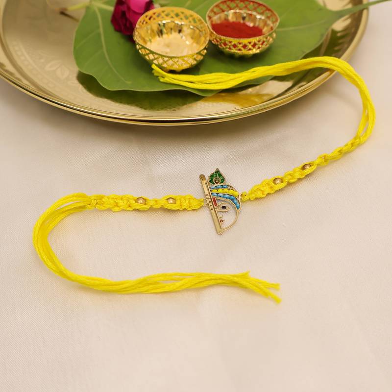 yellow krishna face beaded designer thread rakhi with roli chawal capsules