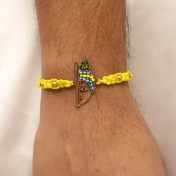 yellow krishna face beaded designer thread rakhi with roli chawal capsules 2