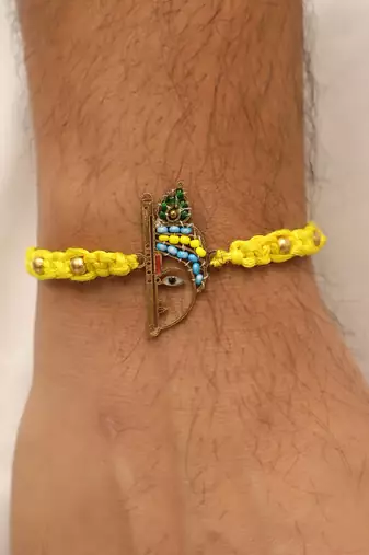 yellow krishna face beaded designer thread rakhi with roli chawal capsules