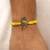 yellow krishna face beaded designer thread rakhi with roli chawal capsules