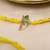 yellow krishna face beaded designer thread rakhi with roli chawal capsules