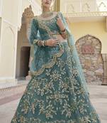 Turquoise sequins and dori embroidered soft net festive & party wear stitched lehenga