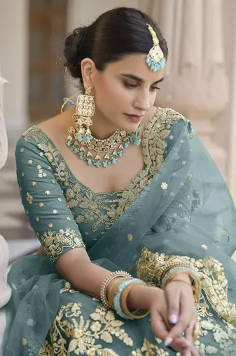Turquoise sequins and dori embroidered soft net festive & party wear stitched lehenga