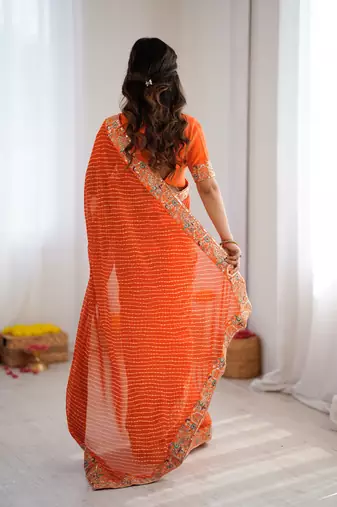 Orange embroidered bandhani print faux georgette saree with unstitched mono benglori silk blouse