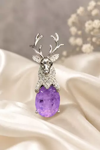 Silver-toned deer brooch pin with purple oval crystal stone