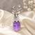 Silver-toned deer brooch pin with purple oval crystal stone