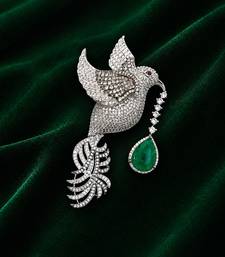 Silver-toned flying bird brooch with green teardrop crystal 