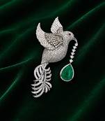 Silver-toned flying bird brooch with green teardrop crystal 