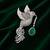 Silver-toned flying bird brooch with green teardrop crystal 