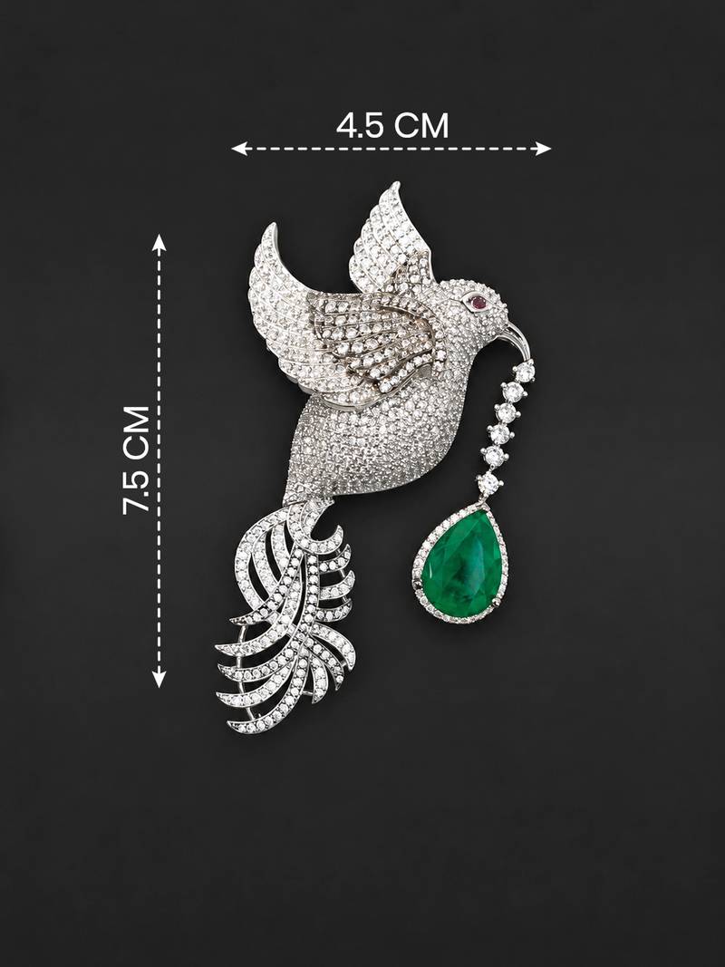 Silver-toned flying bird brooch with green teardrop crystal 