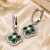 Rhodium finish floral halo dangler earrings