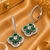 Rhodium finish floral halo dangler earrings