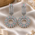 Rhodium finish pastel cz halo dangle earrings