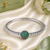 Rhodium finish emerald american diamond bracelet