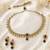 Designer circle and round shape small golden balls blue stone antique gold plated choker jewellery set for women