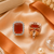 Rose gold finish sunset ember halo studs